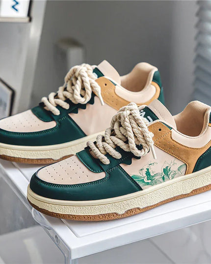 Pair of sneakers with green, beige, and white color scheme on a white surface.