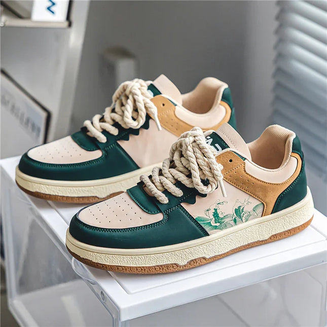 Pair of sneakers with green, beige, and white color scheme on a white surface.
