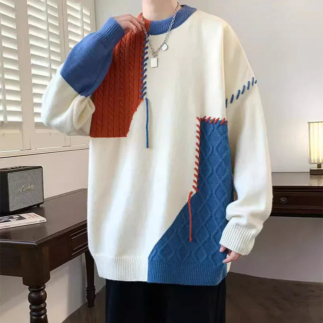 Person wearing a colorful sweater with geometric pattern in a room.