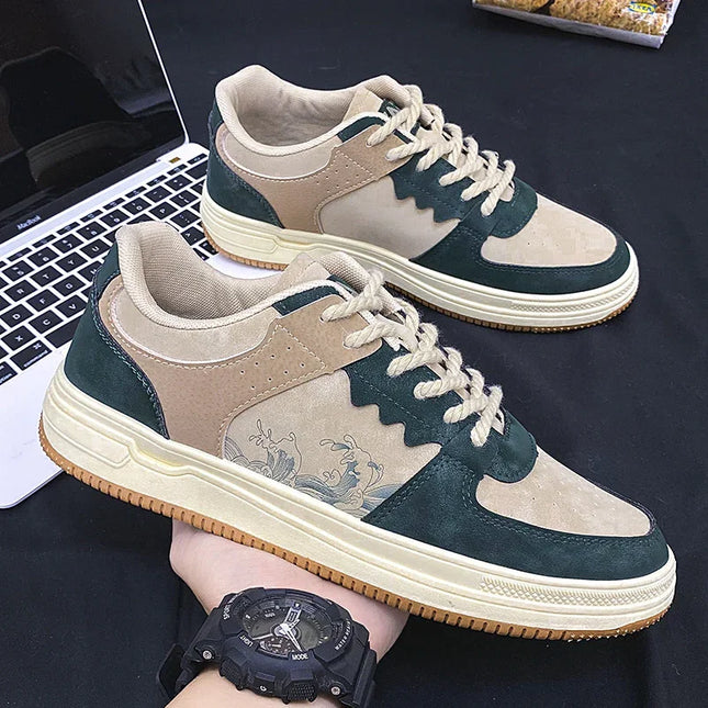 Pair of green and beige sneakers with a laptop in the background