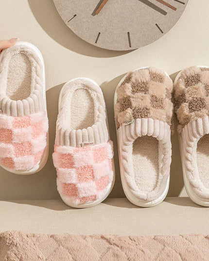 Pair of checkered slippers on a beige surface with a clock in the background