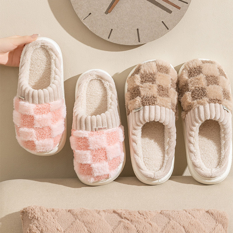 Pair of checkered slippers on a beige surface with a clock in the background