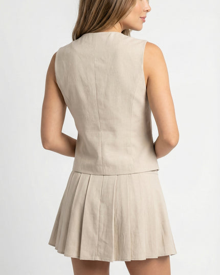Woman wearing a beige sleeveless top and skirt set on a white background