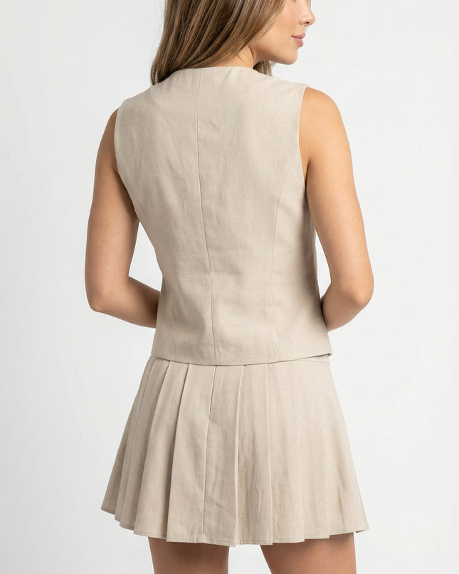 Woman wearing a beige sleeveless top and skirt set on a white background