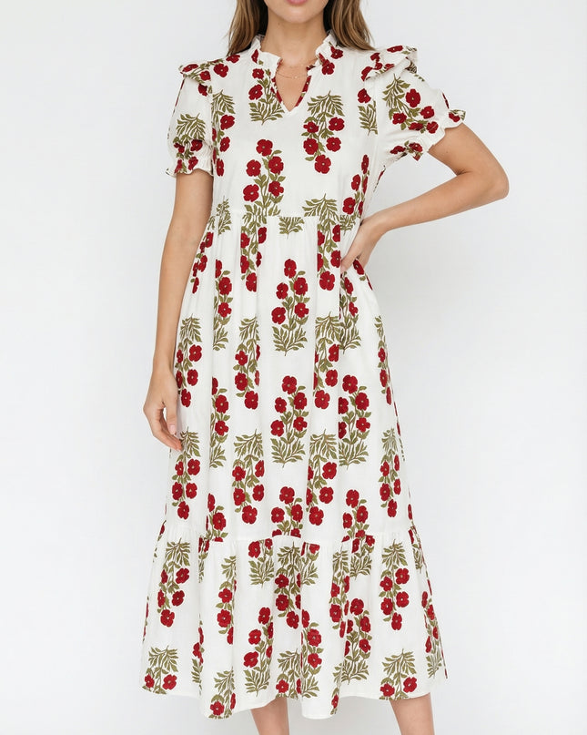 Woman wearing a white dress with red floral pattern on a white background