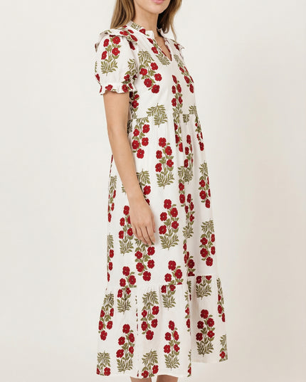 Woman wearing a white dress with red floral pattern on a white background