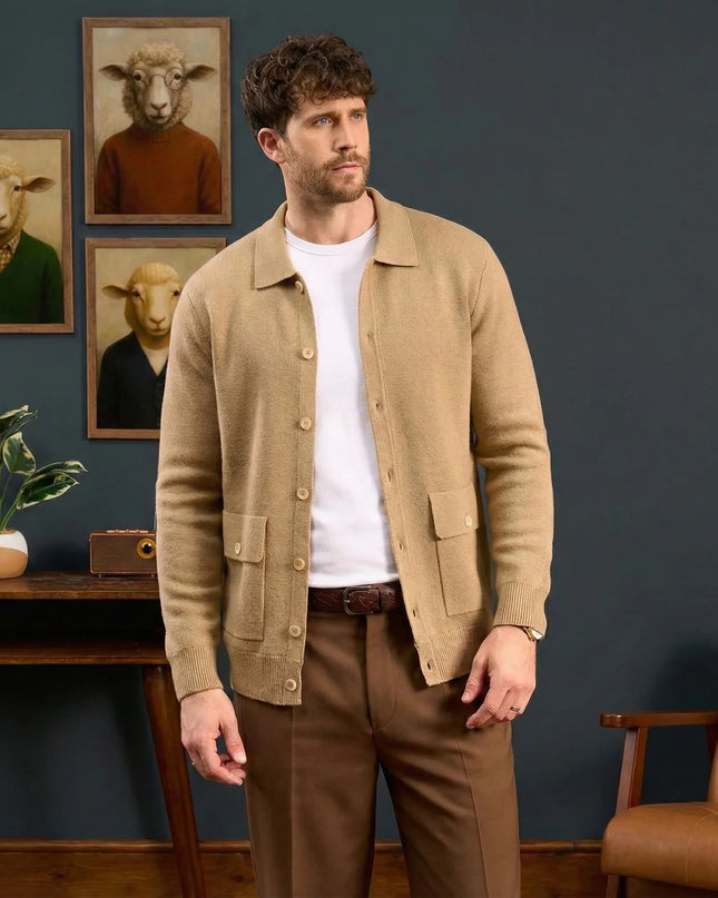 Man wearing a beige jacket and brown pants standing in a room with framed pictures of animals on the wall.