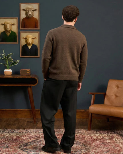 Man standing in a room with framed animal portraits on the wall.