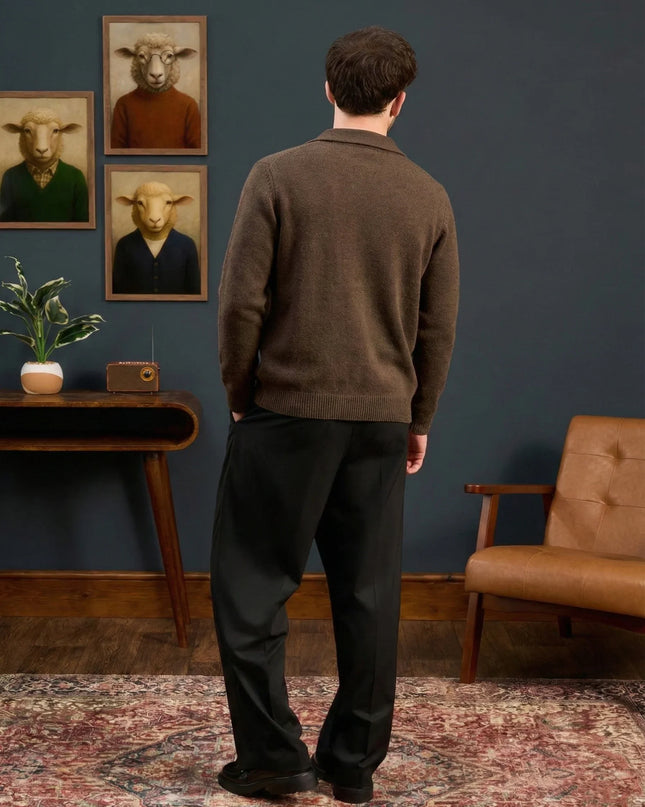 Man standing in a room with framed animal portraits on the wall.