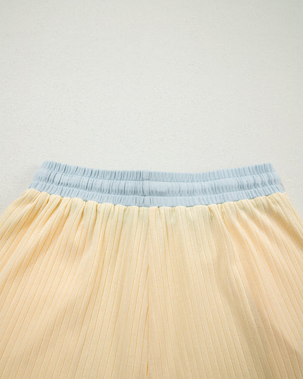 Close-up of a beige skirt with a blue waistband on a light gray background