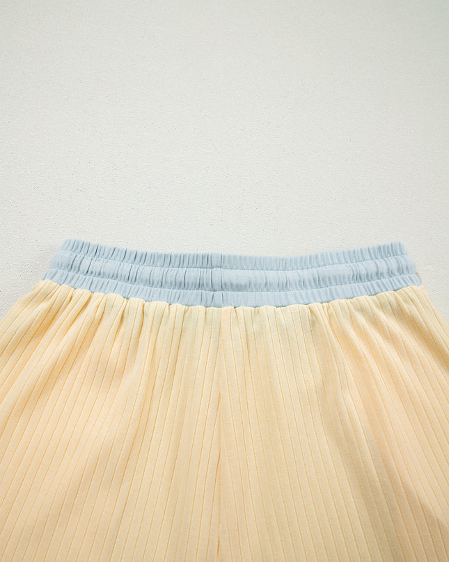 Close-up of a beige skirt with a blue waistband on a light gray background