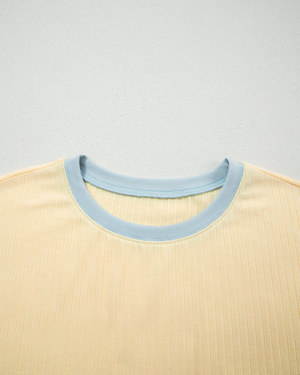 Close-up of a beige shirt with a light blue collar on a light gray background