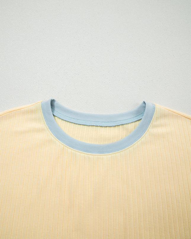 Close-up of a beige shirt with a light blue collar on a light gray background