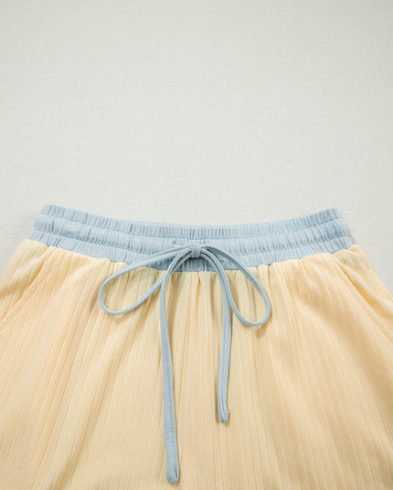 Beige shorts with a light blue waistband and drawstring on a light gray background