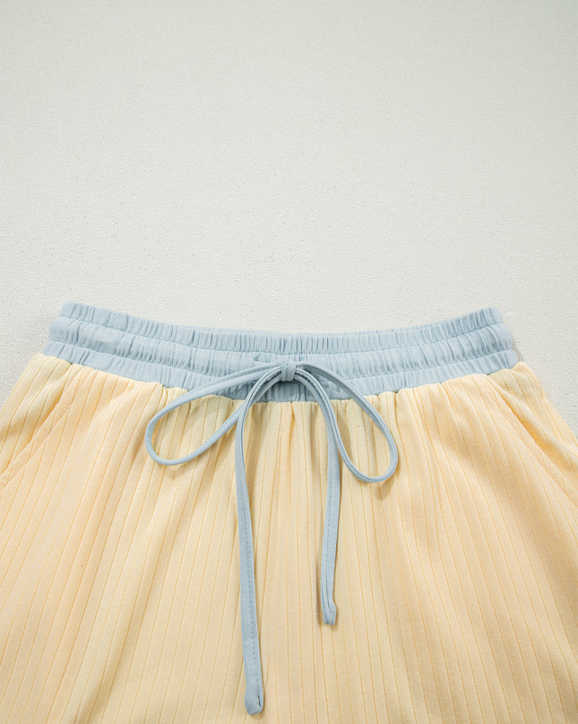 Beige shorts with a light blue waistband and drawstring on a light gray background