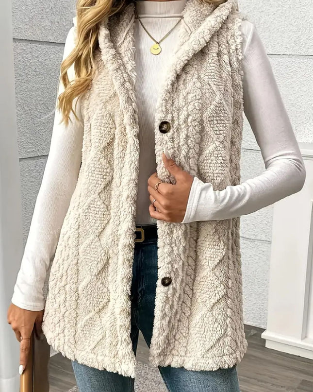 Person wearing a beige fleece vest over a white long-sleeve shirt and jeans.