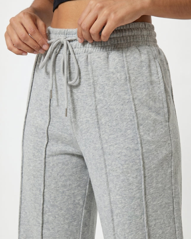 Gray sweatpants with a black top on a white background