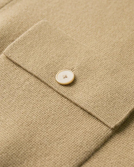 Close-up of a beige fabric with a button on a textured surface