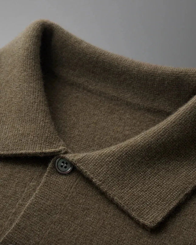 Close-up of a brown coat collar with buttons on a gray background