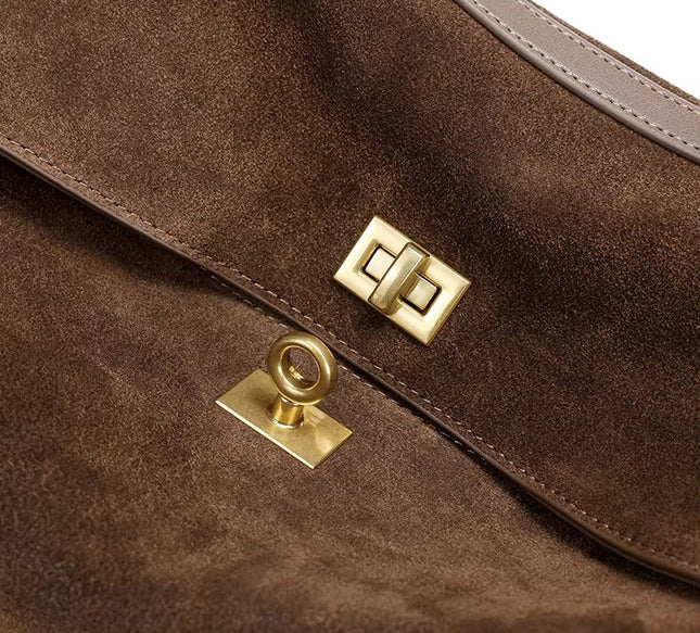 Close-up of a brown leather bag with gold hardware