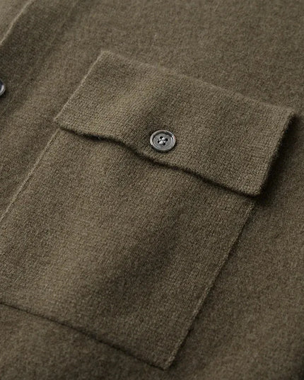 Close-up of a brown textured fabric with a button on a garment.