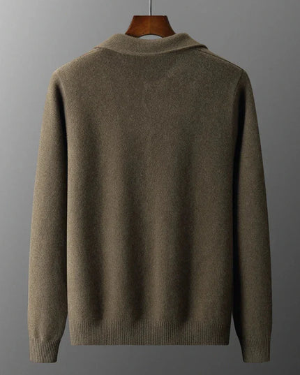 Brown sweater on a hanger against a gray background
