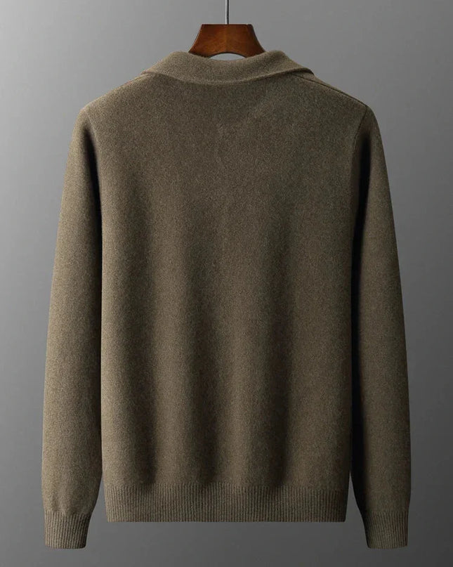 Brown sweater on a hanger against a gray background