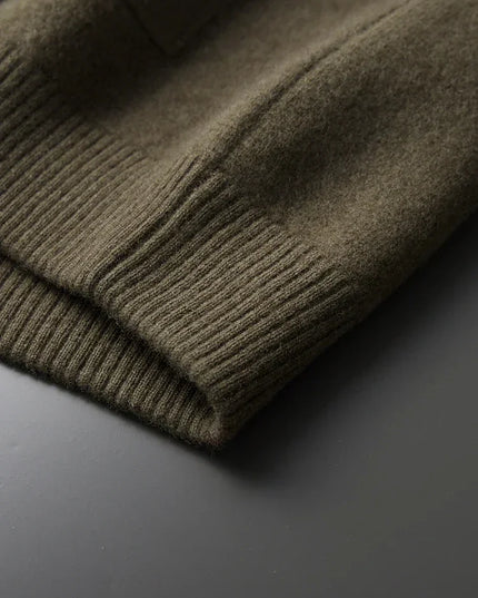 Close-up of a green sweater on a dark surface