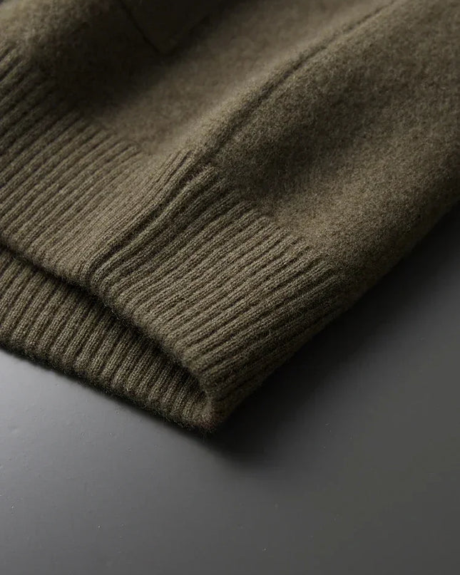 Close-up of a green sweater on a dark surface