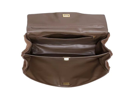 Brown leather bag with gold hardware on a white background