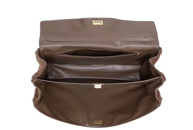 Brown leather bag with gold hardware on a white background