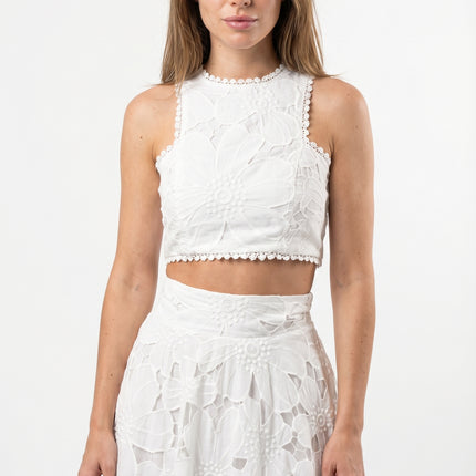 Woman wearing a white lace outfit on a white background