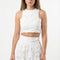 Woman wearing a white lace outfit on a white background