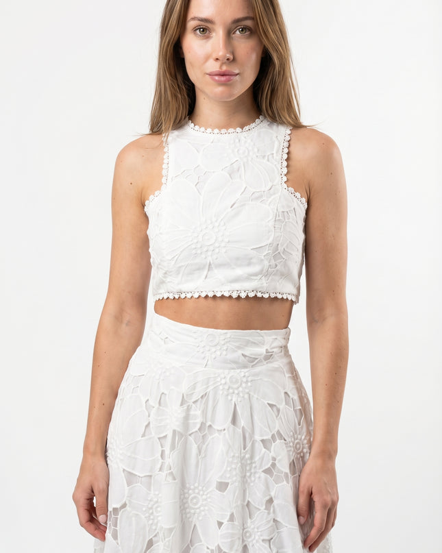 Woman wearing a white lace outfit on a white background