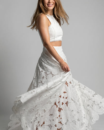 Woman wearing a white lace dress on a gray background
