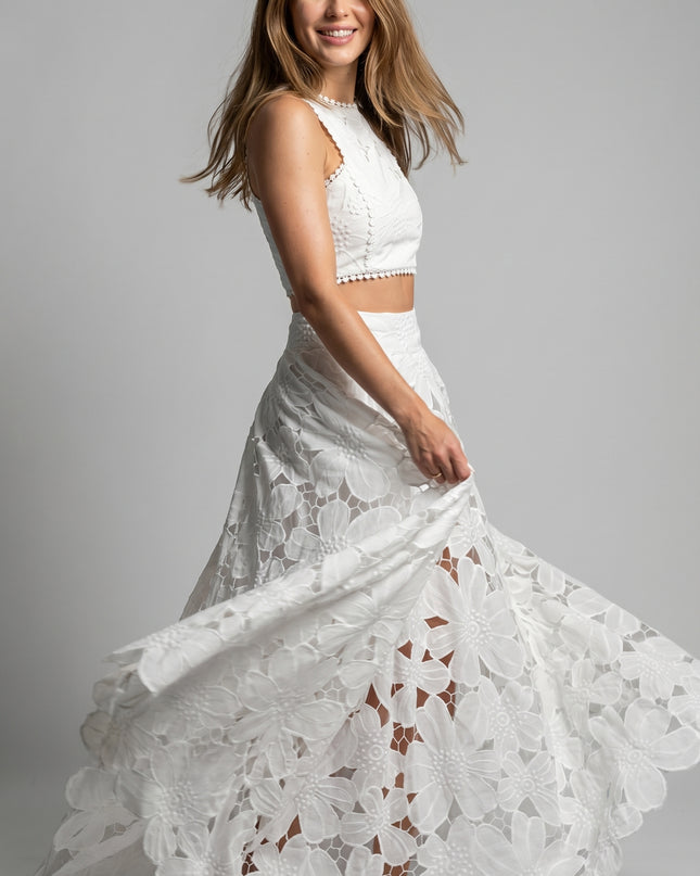 Woman wearing a white lace dress on a gray background