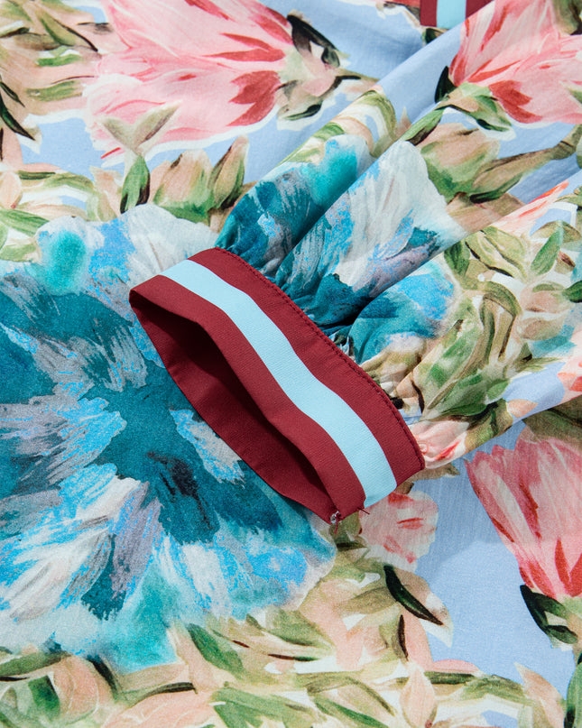 Colorful floral-patterned fabric with a red and white striped object on top