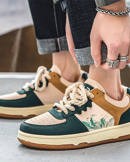 Person wearing a pair of green and brown sneakers with floral design on a concrete surface.