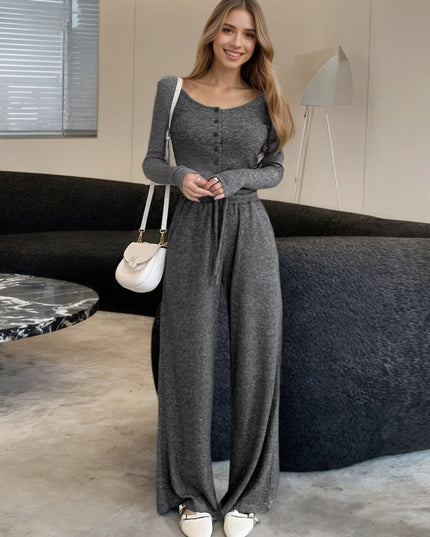 Woman wearing a long gray dress in an indoor setting