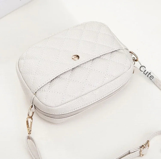 White glittery handbag with gold chain strap on a white background