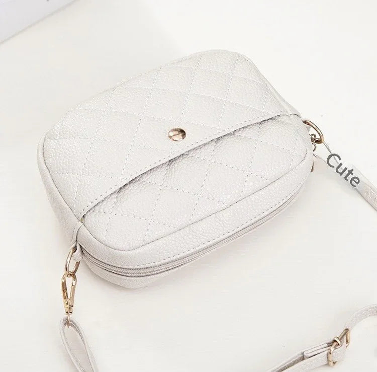 White glittery handbag with gold chain strap on a white background