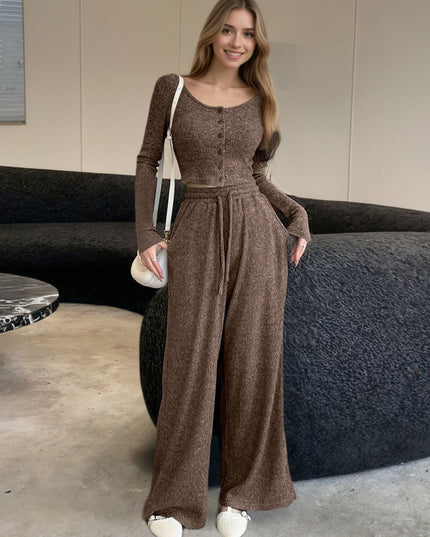 Woman wearing a brown jumpsuit in an indoor setting