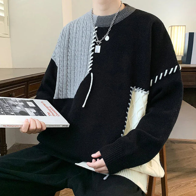 Person wearing a black and gray sweater holding a book in a room.