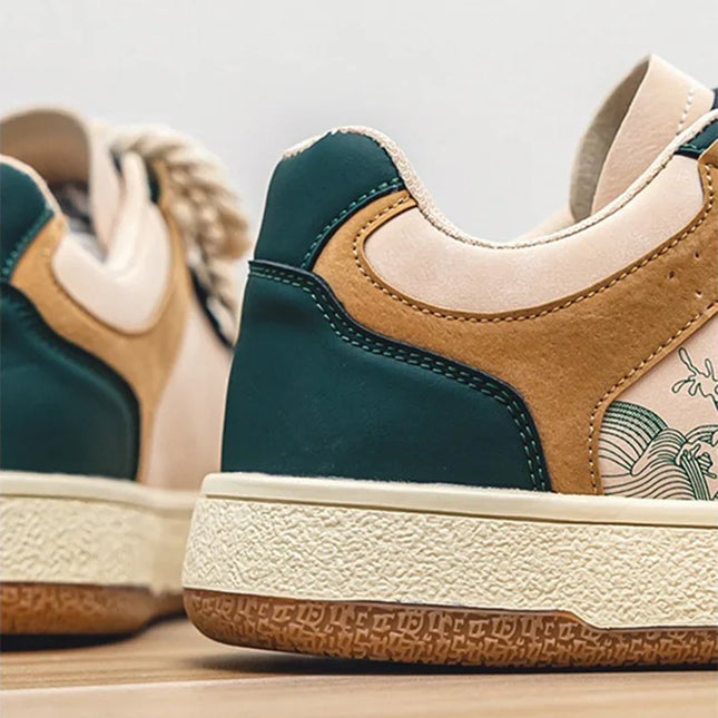 Close-up of a pair of green and brown sneakers with beige soles.