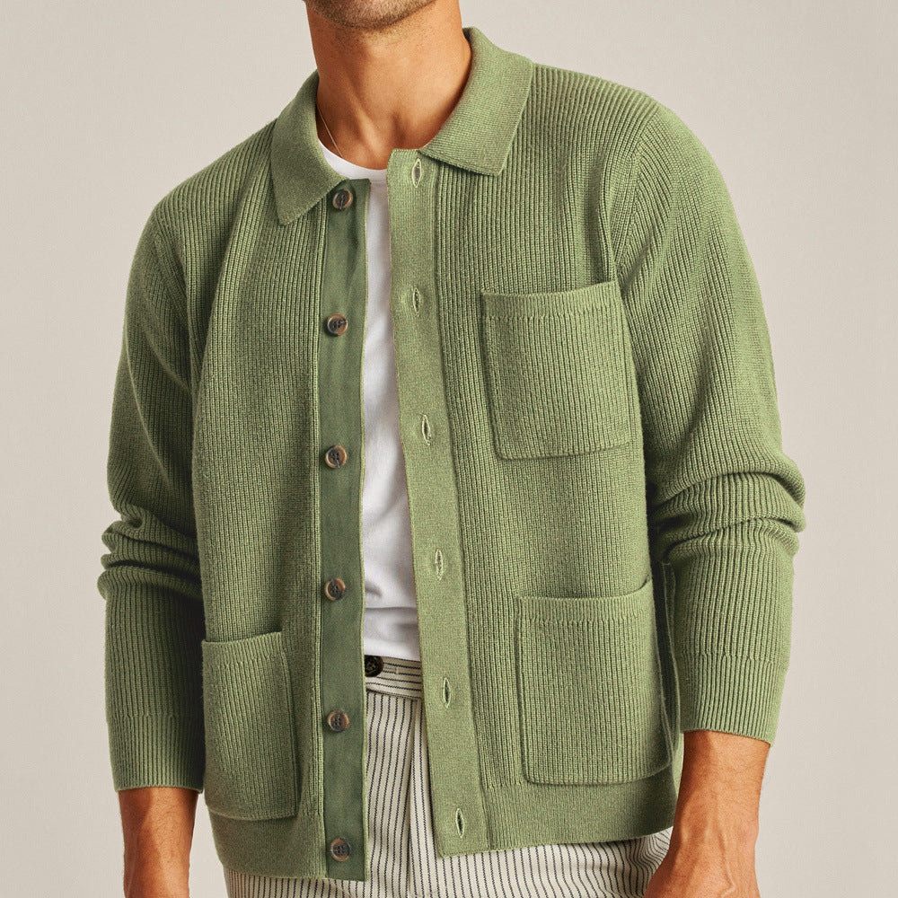 Green knitted cardigan worn by a person on a plain background