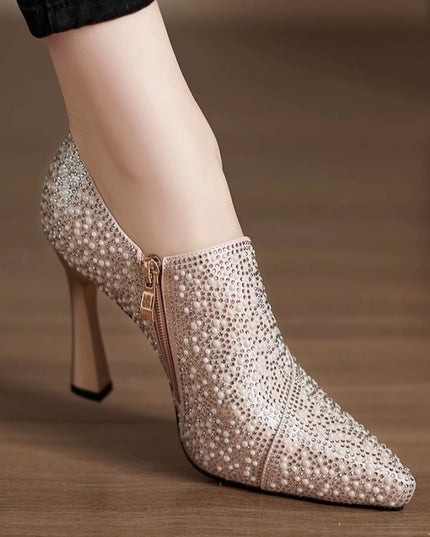 High-heeled shoe with sparkling embellishments on a blurred background