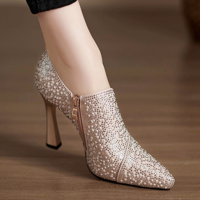 High-heeled shoe with sparkling embellishments on a blurred background
