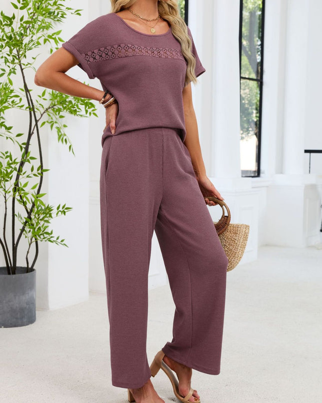 Woman wearing a purple outfit in a bright room with a plant and window.