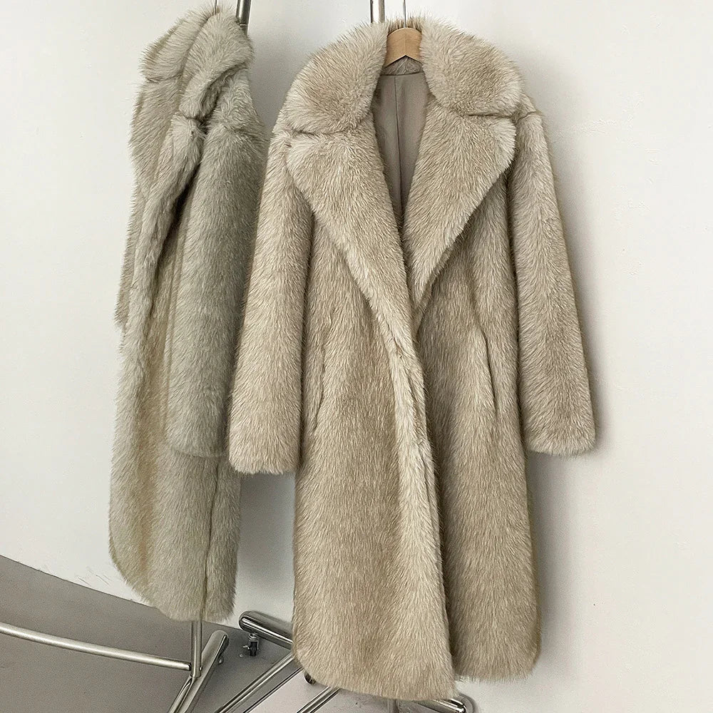 Two beige faux fur coats hanging on a rack against a white wall.