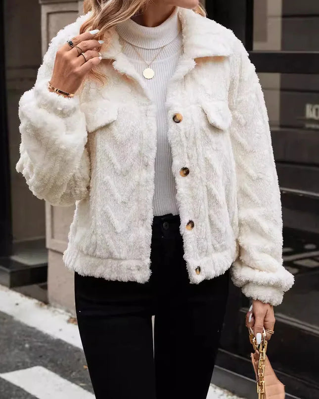 Person wearing a white fluffy jacket with brown buttons in an urban setting